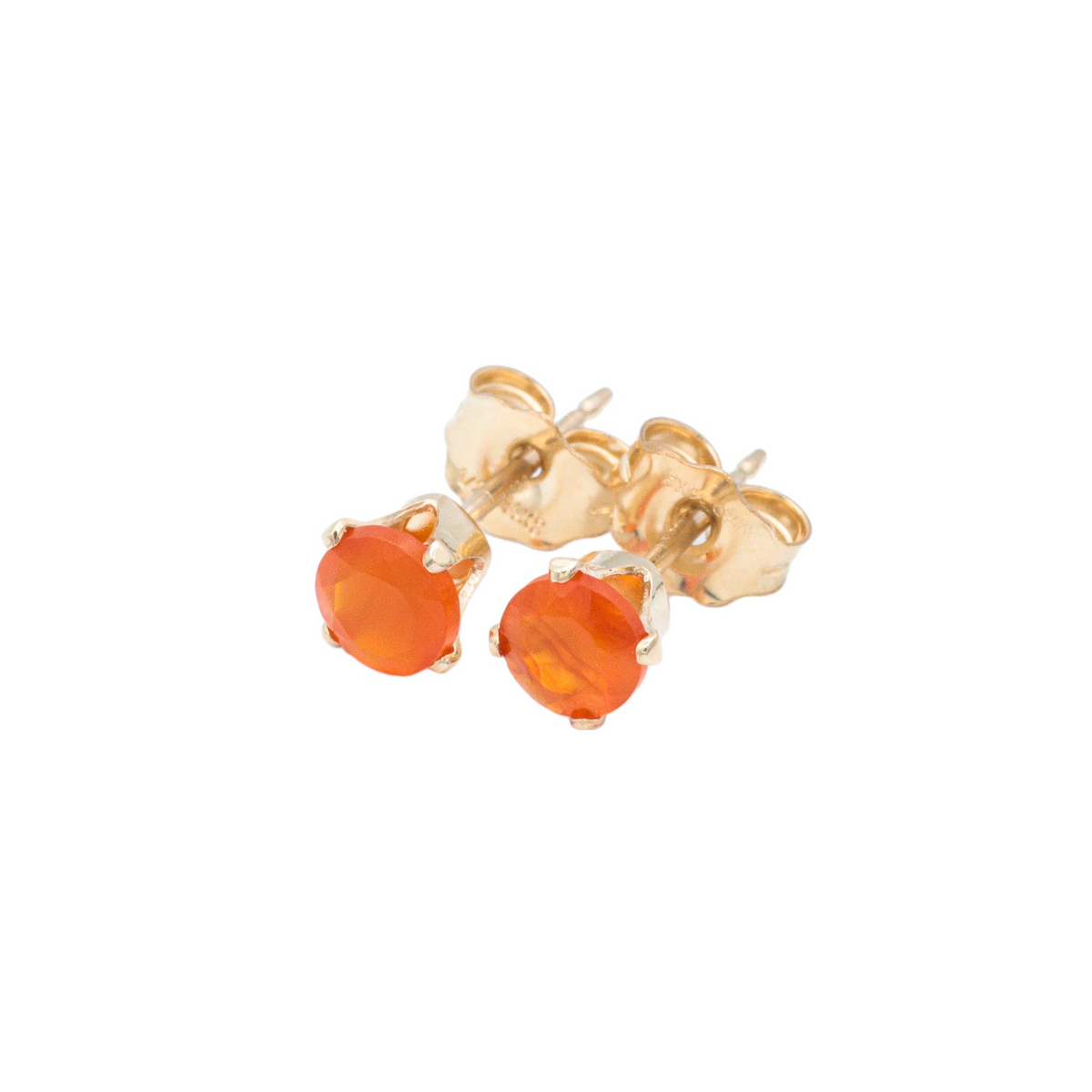 a pair of gold earrings with an orange stone