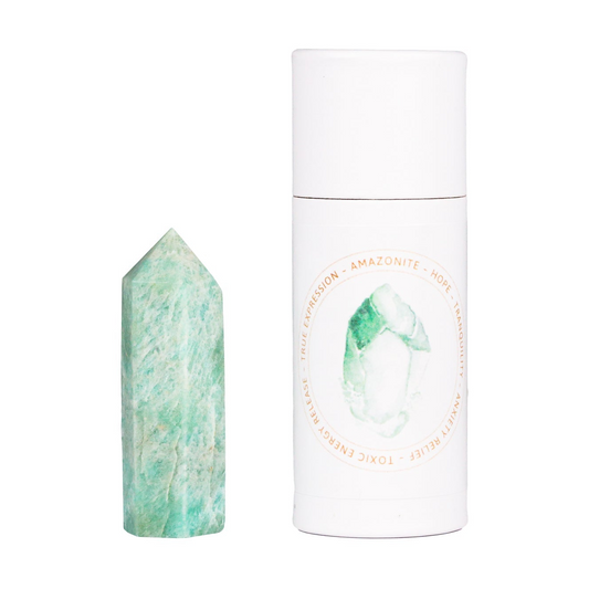 a green stone next to a white tube of deodorant