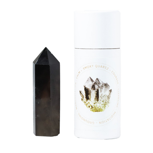 a black stone next to a white container