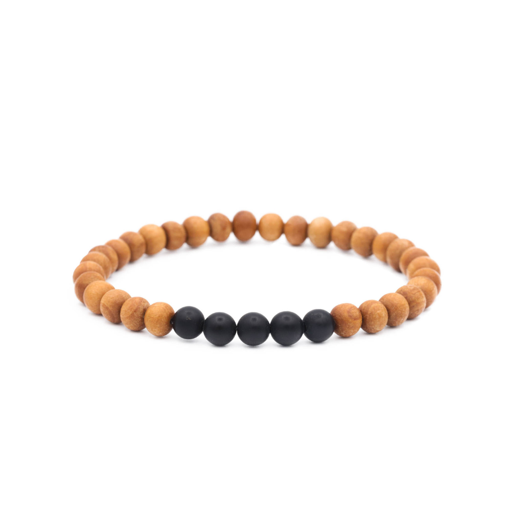 a wooden bracelet with two black beads