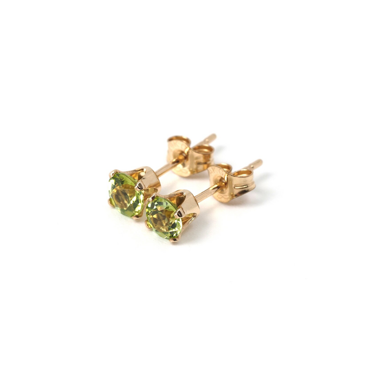 a pair of gold earrings with green stones