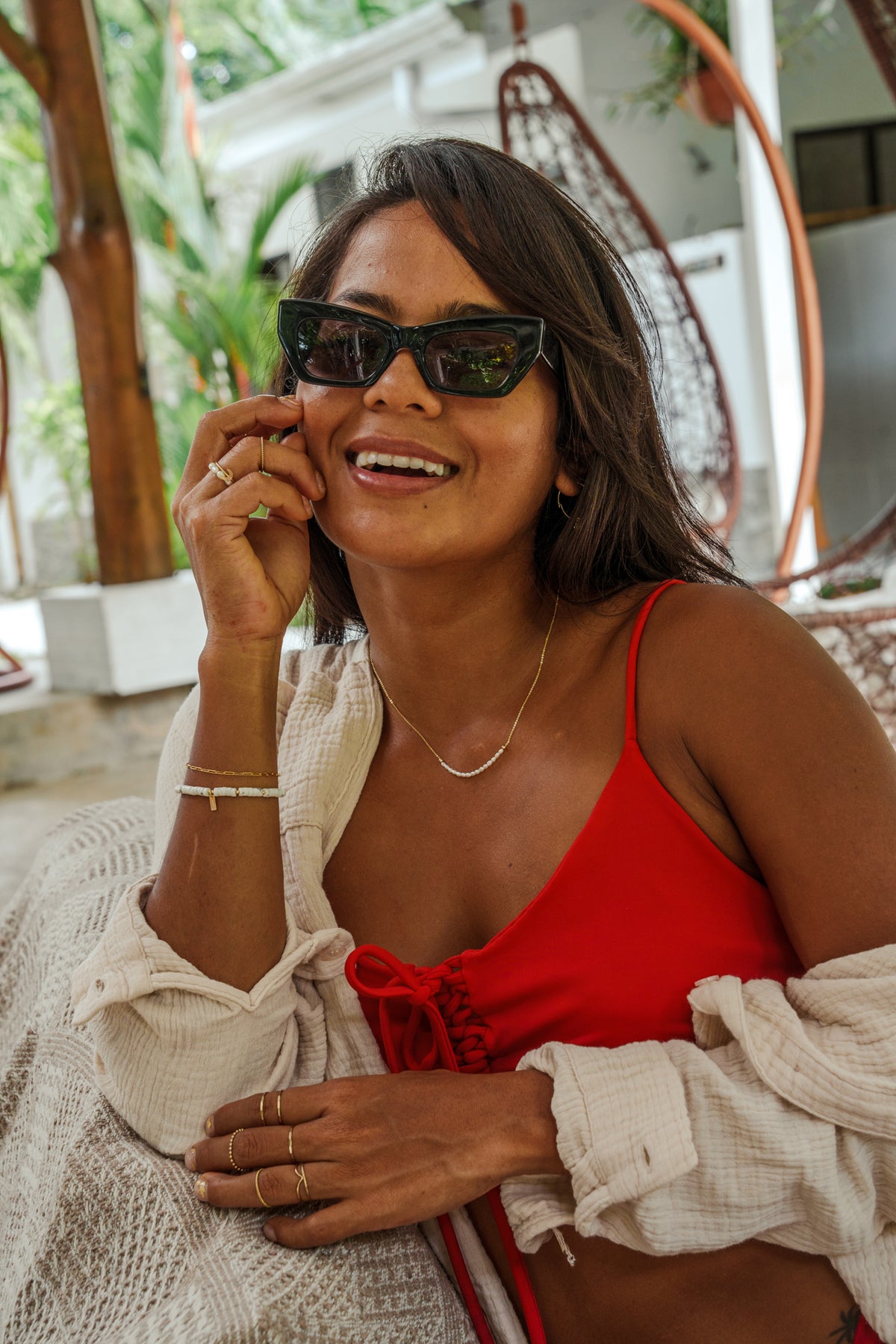 a woman in a red top talking on a cell phone