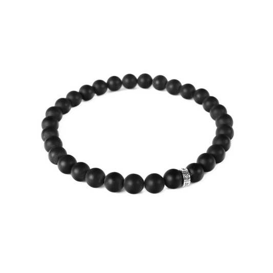a black beaded bracelet on a white background