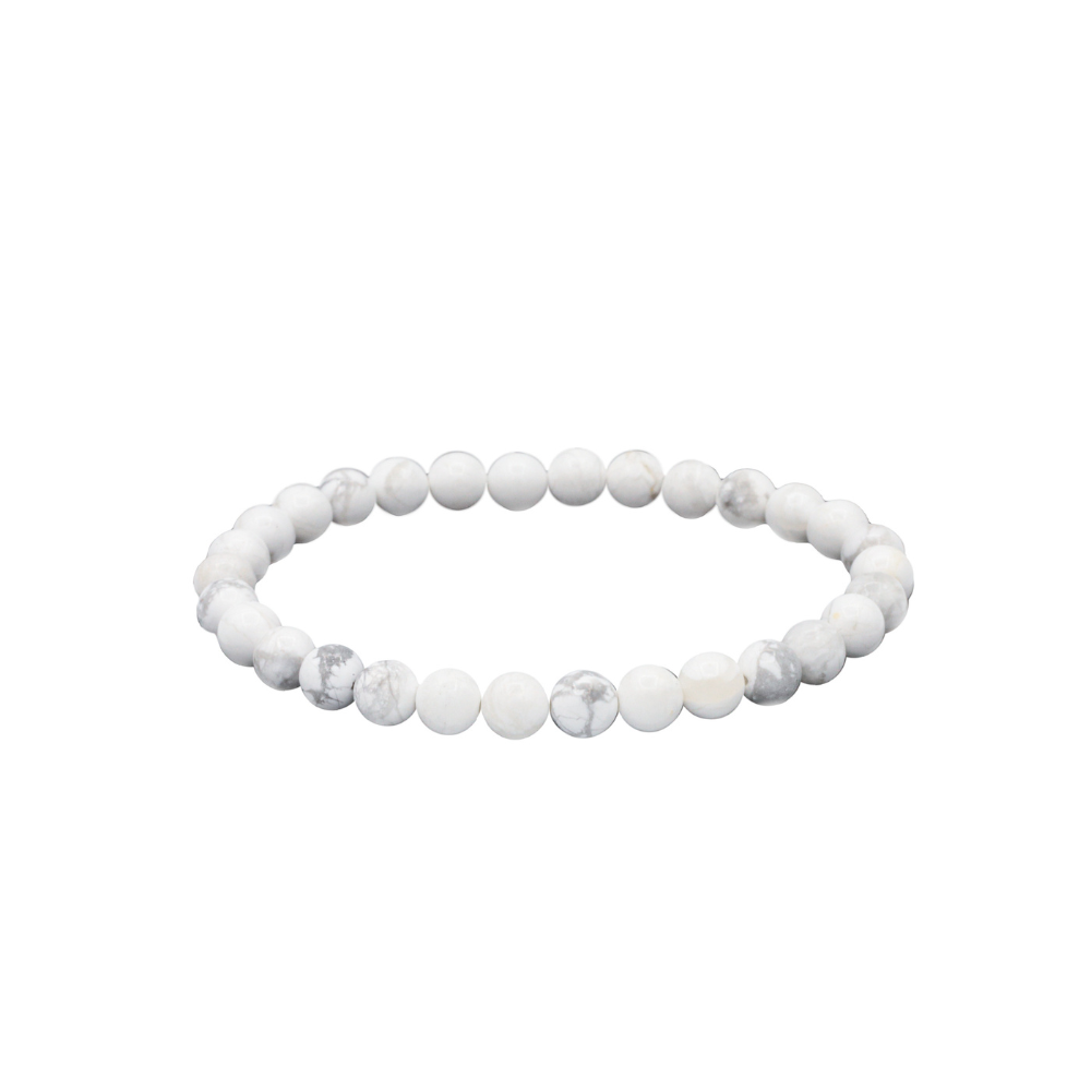 a white beaded bracelet on a white background