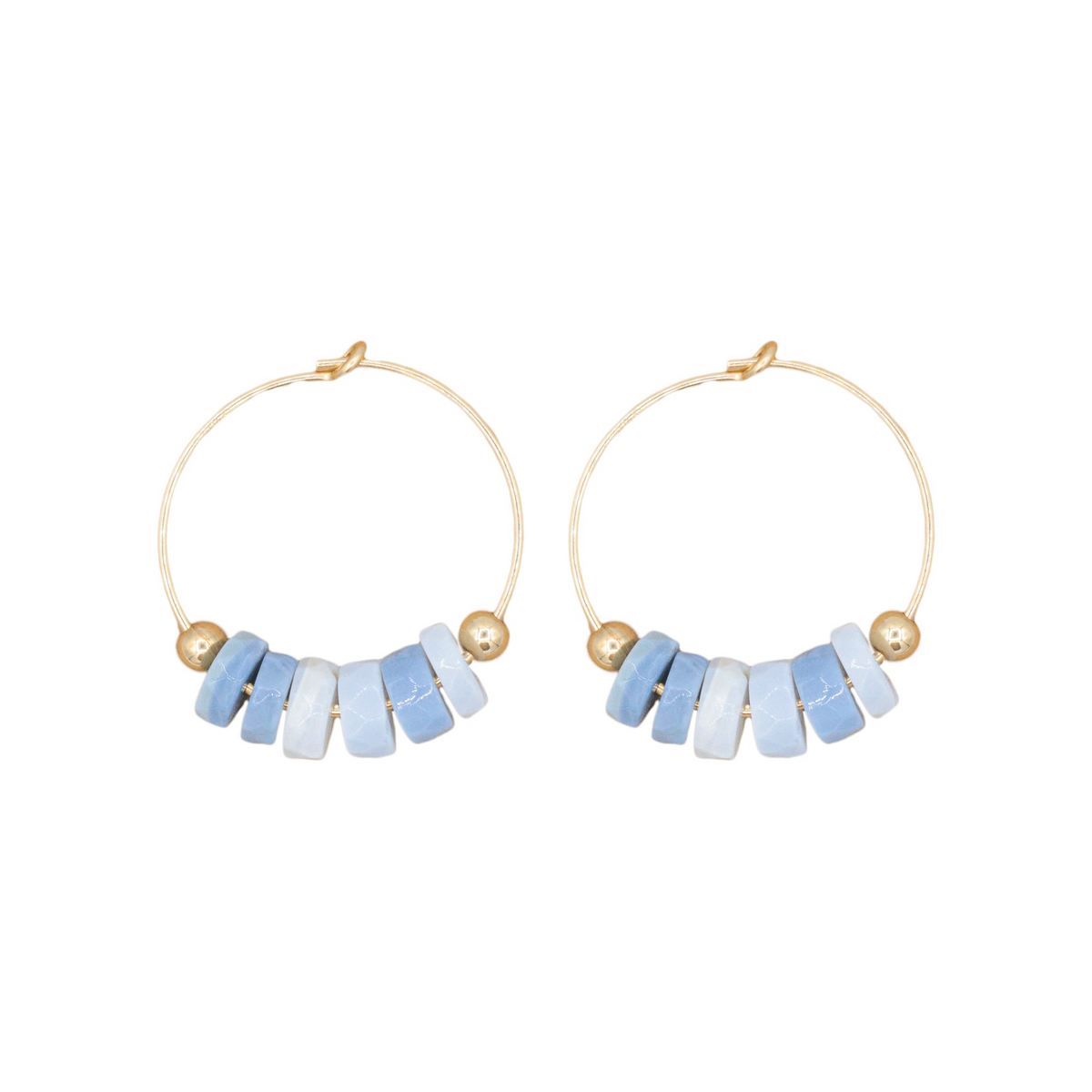 a pair of hoop earrings with blue beads