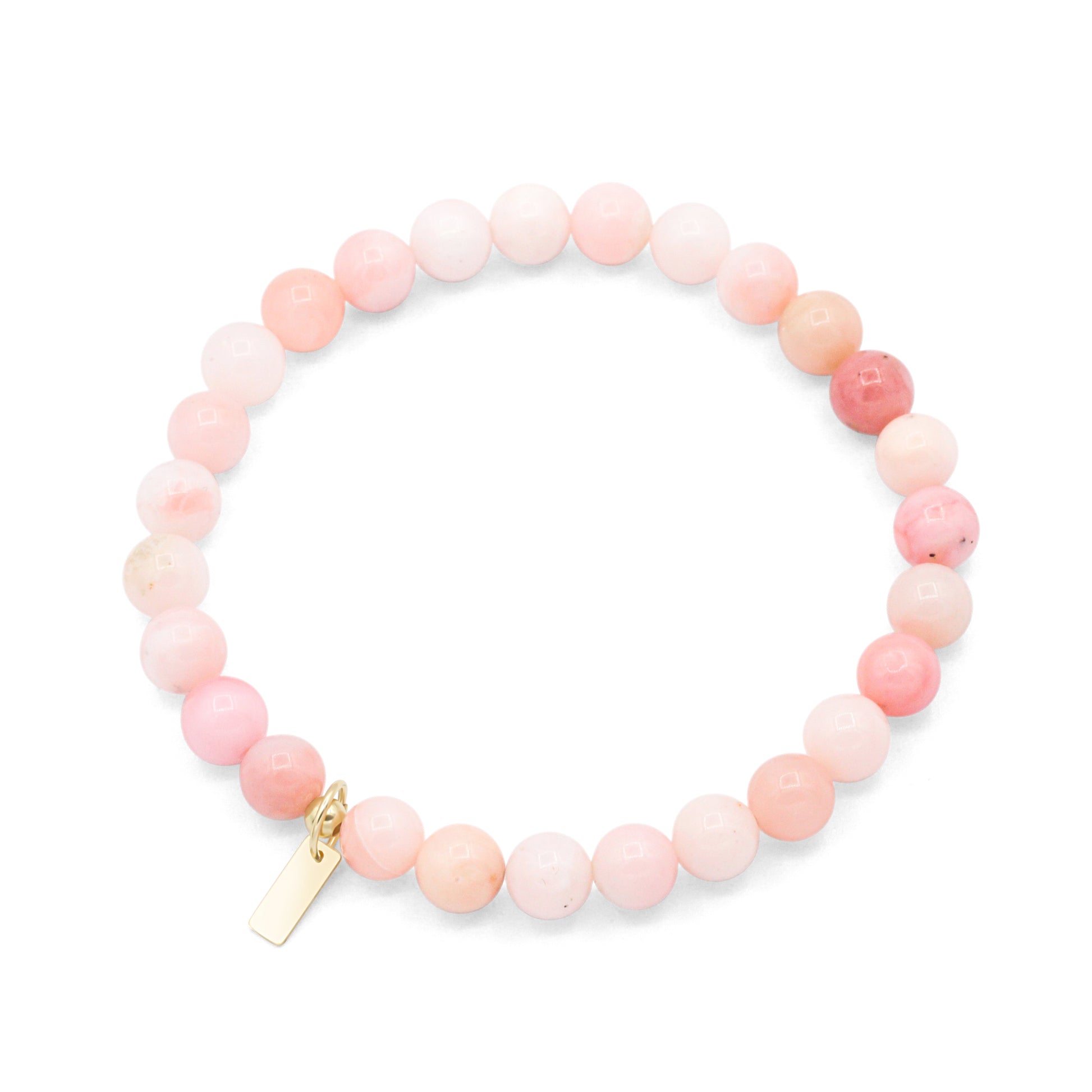 A bracelet made of small, round beads in shades of pink and peach, with a gold-colored charm attached to the end.